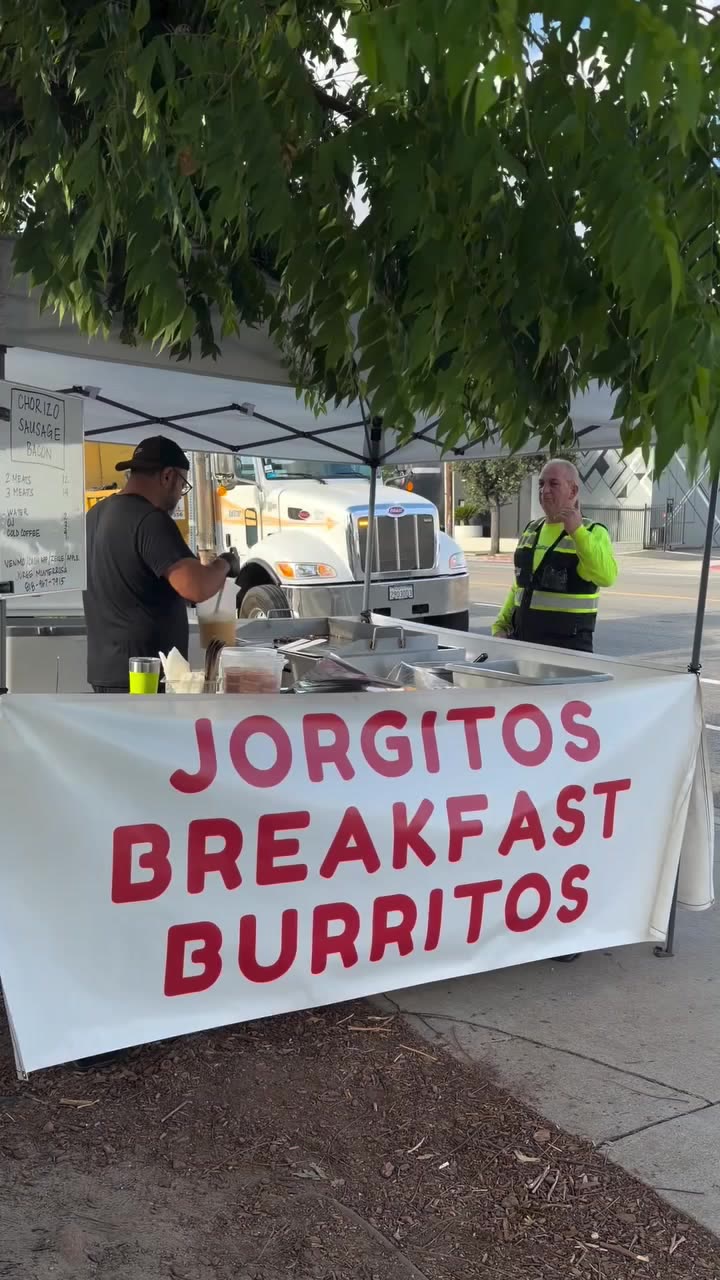 The Jorgito's Breakfast Burritos stand with its red and white banner under a white tent